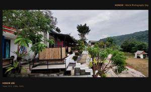 a building with benches and trees in a yard at Phulanta Resort in Ko Lanta Yai