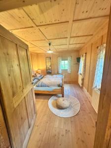 a bedroom with a bed in a wooden room at Ferienwohnung Eggerhof-Schaller in Innervillgraten