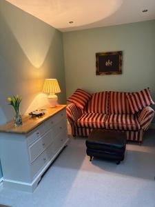 a living room with a couch and a table at Hatters Cottage in Bingley