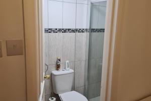 a bathroom with a toilet and a shower at 4Br-2Ensuite-10minCentralLondon-Sleeps11-Parking in London