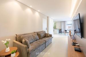 a living room with a couch and a table at Apto c/ Churrasqueira a 500m da Praia TDF0302 in Itapema