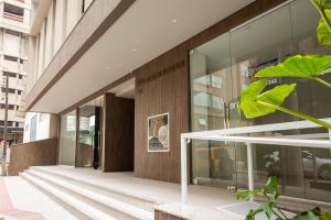 a facade of a building with glass windows at Apto c/ Churrasqueira a 500m da Praia TDF0302 in Itapema