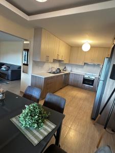 a kitchen and living room with a table and chairs at ANTHEMIs COTTAGE RED in Kyperounda