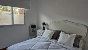 En eller flere senge i et værelse på Verto Departamentos