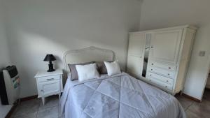 En eller flere senge i et værelse på Verto Departamentos