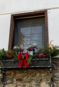 a window sill with flowers and a red bow at Villa Aurelia Old Town in Kavala