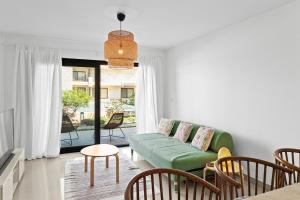 a living room with a green couch and chairs at The G Cribs Sunlit - El Gouna in El Gouna