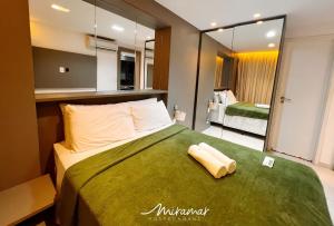 a bedroom with a large green bed with a mirror at Holandas Prime Tambaú in João Pessoa +176 photos