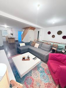 a living room with a couch and a table at MAISON SERENITY Bohars in Bohars