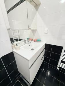 a white bathroom with a sink and a mirror at MAISON SERENITY Bohars in Bohars +27 photos