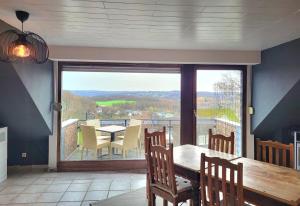 a dining room with a table and a large window at Weltmann`s Hotel & Restaurant in Ennepetal