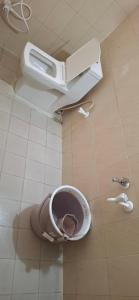 a toilet with its seat up in a bathroom at Ashwin Home Stay in Tiruvannāmalai +29 photos