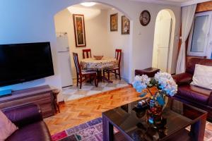 a living room with a tv and a table at Milenijum apartman in Podgorica
