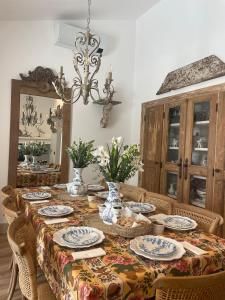a dining room with a table with plates and chairs at Casa do Juiz in Barca da Amieira +32 photos