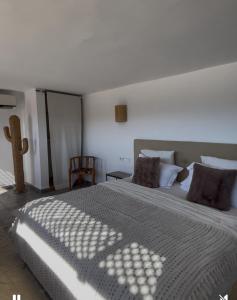 a bedroom with a large bed with a white bedspread at Patio du Lac in Lalla Takerkoust
