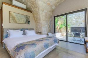 a bedroom with a large bed and a large window at Casa de Thoum in Batroûn +63 photos