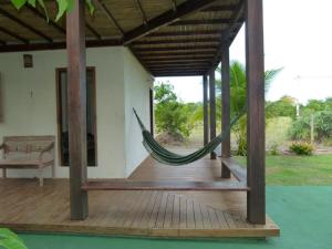 a hammock on the porch of a house at Jasmim Manga in Marau
