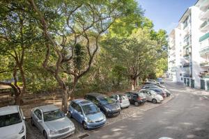 a row of cars parked on the side of a street at BeGuest Jardim Quinta da Alagoa Luxury Stay in Carcavelos
