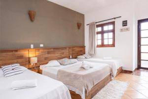 a bedroom with three beds in a room at Pousada In Bali - Maresias in Maresias +122 photos