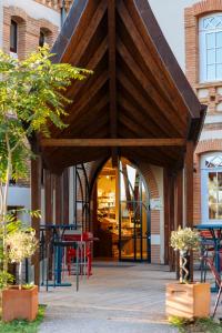 a restaurant with tables and chairs in front of a building at Hotellerie de l'Abbaye du Désert in Bellegarde +39 photos