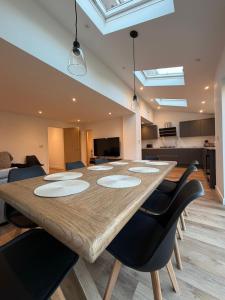 a dining room with a large wooden table and chairs at Luxury House, Great Location in Redditch - Contractors - Families - Groups - Relocators - Sleeps 9 in Bentley