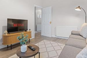 a living room with a couch and a tv at Contractors, Free Parking, TV, Discounts, Wi-Fi in Wallasey +42 photos
