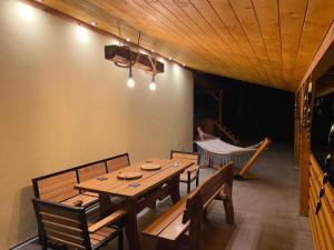 a dining room with a wooden table and chairs at Apartament na lipowej in Pastwiska +1 photo