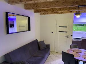 a living room with a couch and a table at Apartament na lipowej in Pastwiska