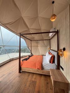 a bedroom with a canopy bed in a tent at Astara Munnar in Anachal