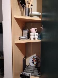 a cupboard with dishes and a laptop on it at Casa PALLINA FIDENZA in Fidenza +20 photos