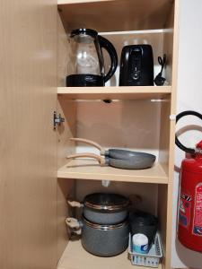a cupboard with a pot and pans and a blender at Casa PALLINA FIDENZA in Fidenza