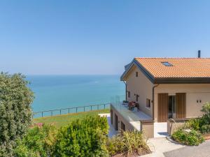 a house with a view of the ocean at Terrazza Incanti - Piscina e Magia al Tramonto in Fiorenzuola di Focara