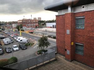 a view of a parking lot with cars parked on the street at The Point Apartment, Leeds City Center in Leeds