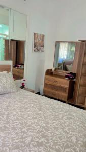 a bedroom with a bed and a dresser and a mirror at Elégance & Confort in Rabat