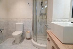 a bathroom with a toilet and a shower and a sink at Villa Amalia  +11 photos