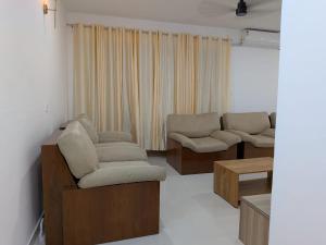 a living room with two chairs and a couch at 3 bhk apartment for rent in Kakkanad near infopark in Kakkanad