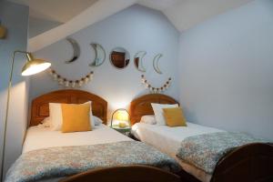 two beds in a room with moon signs on the wall at Villa Amalia 