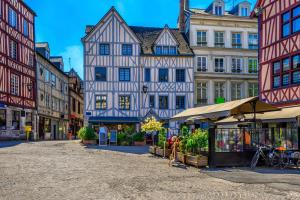 a street in a city with buildings and shops at Jasmin in Rouen