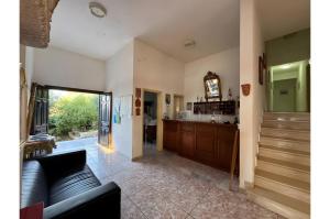 a living room with a couch and a clock at Apraos Bay Hotel in Apraos