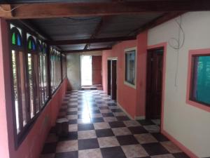 a hallway of a building with a checkered floor at Hospedaje Tiyox Aab'aj in San Juan La Laguna
