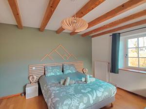 En eller flere senge i et værelse på Le Repaire de la Chouette