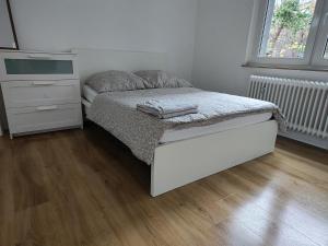 a small bedroom with a bed and a dresser at LivingStation Essen R1 bis R4 in Essen