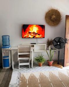 een woonkamer met een open haard aan de muur bij Elala Studio Homes in Diani Beach