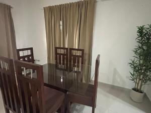 a dining room with a glass table and chairs at Villa de Philippe - Brisas de PC · 3BR House with private pool - Near downtown in Punta Cana