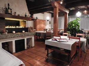 a restaurant with tables and chairs and a fireplace at Gasthof Sonne in Horriwil