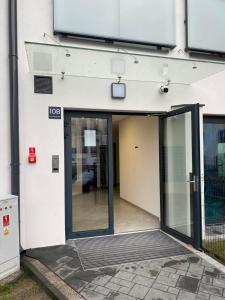 un ingresso a un edificio con porta scorrevole in vetro di Apartament Kołobrzeska 2 a Piła 1 altra foto