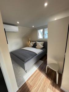 una piccola camera da letto con un letto e una sedia di Lumio Apartment 2 a Karlsruhe
