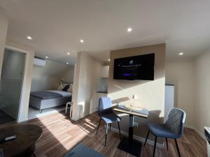 a living room with a couch and a table with chairs at Lumio Apartment 2 - Klimatisiert - Coffee for free - in Karlsruhe