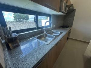 a kitchen counter with a sink and a window at Ecos del Mar 1 - Villa 31 · 3BR Tropical villa near Downtown in Punta Cana +22 photos