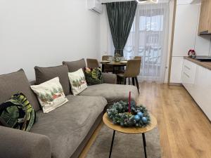 a living room with a couch and a table at Panoramic RESIDENCE in Baia Mare
